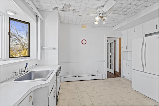 1228 Wells Pl, Stratford, CT 06615 - kitchen featuring freestanding refrigerator, baseboard heating, ceiling fan, light countertops, and a sink
