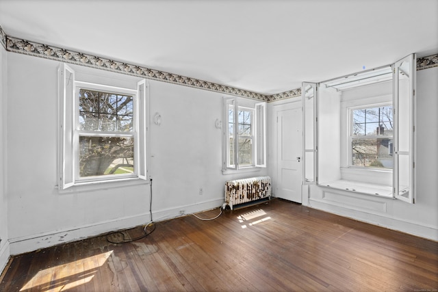 1228 Wells Pl, Stratford, CT 06615 - spare room with hardwood / wood-style floors, radiator heating unit, and baseboards
