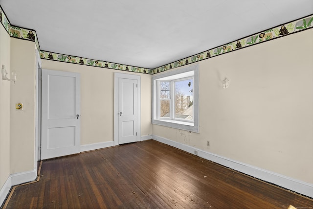 1228 Wells Pl, Stratford, CT 06615 - unfurnished bedroom featuring baseboards, dark wood-type flooring, and a closet