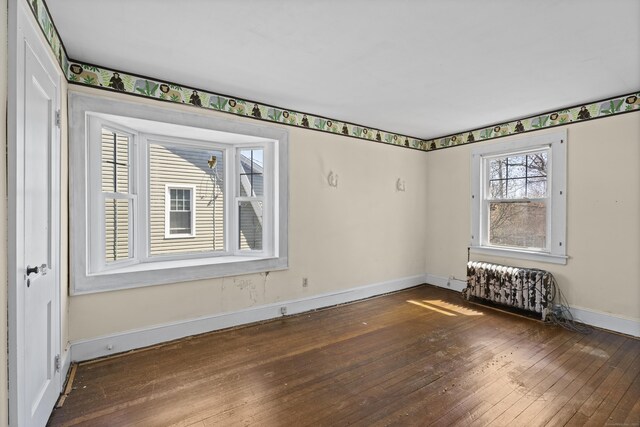 1228 Wells Pl, Stratford, CT 06615 - spare room with hardwood / wood-style floors, baseboards, and radiator