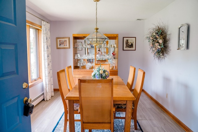 33 Oxford Dr, South Windsor, CT 06074 - dining space with light wood-style floors, a baseboard heating unit, baseboards, and a chandelier
