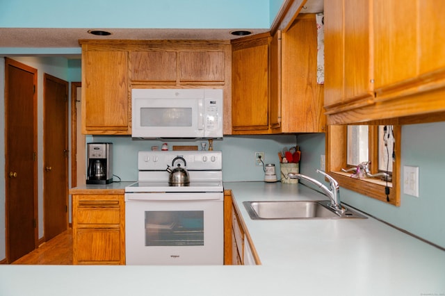 33 Oxford Dr, South Windsor, CT 06074 - kitchen with white appliances, a sink, brown cabinets, and light countertops