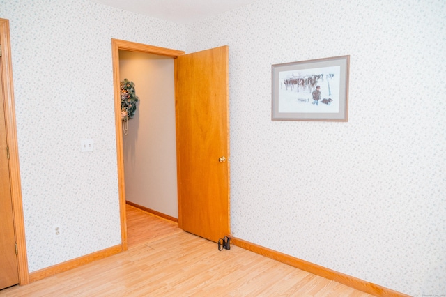 33 Oxford Dr, South Windsor, CT 06074 - empty room with wood finished floors, wallpapered walls, and baseboards
