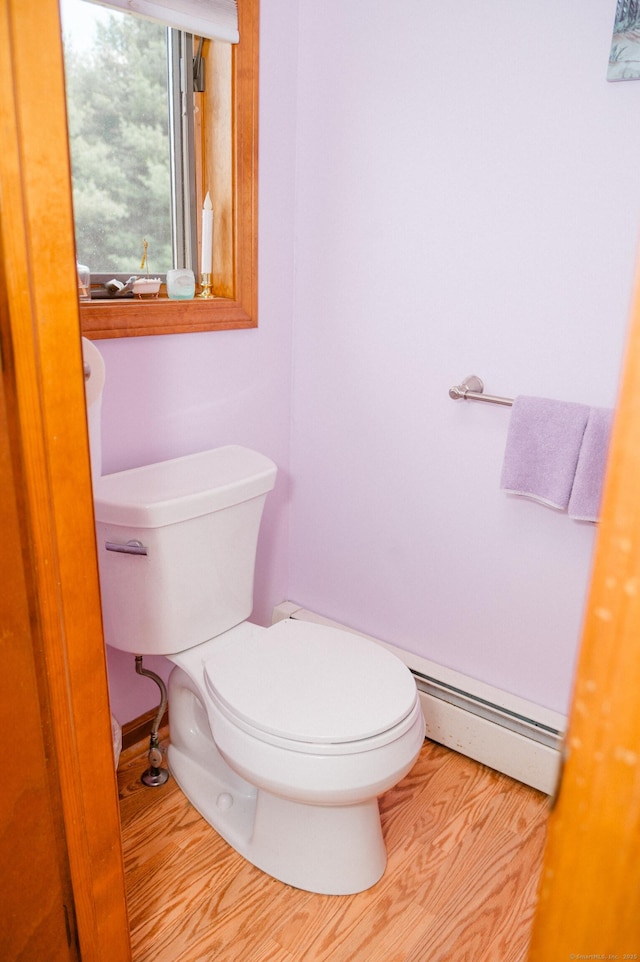 33 Oxford Dr, South Windsor, CT 06074 - half bath with a baseboard heating unit, toilet, and wood finished floors