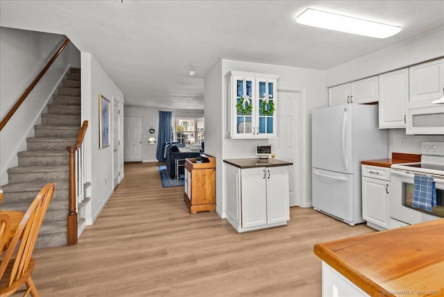 13 Brantwood Dr Unit 13, Madison, CT 06443 - kitchen with white appliances, white cabinetry, light wood finished floors, glass insert cabinets, and tasteful backsplash