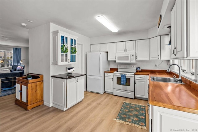 13 Brantwood Dr Unit 13, Madison, CT 06443 - kitchen with white appliances, a sink, light wood-style flooring, and white cabinetry