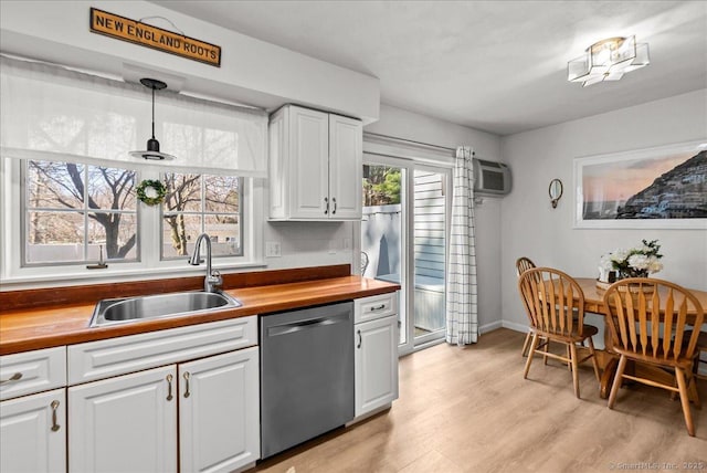 13 Brantwood Dr Unit 13, Madison, CT 06443 - kitchen featuring dishwasher, a sink, wooden counters, light wood-style floors, and white cabinets