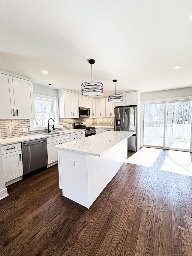 88 Walnut Trl, Danbury, CT 06810 - kitchen with appliances with stainless steel finishes, a sink, a center island, dark wood-style flooring, and backsplash