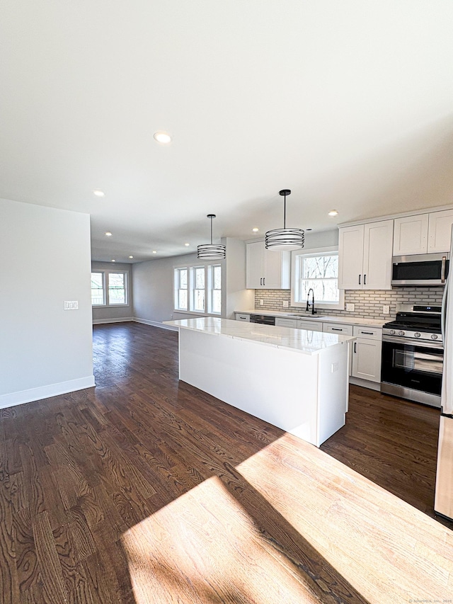 88 Walnut Trl, Danbury, CT 06810 - kitchen with stainless steel appliances, a kitchen island, recessed lighting, healthy amount of natural light, and dark wood finished floors