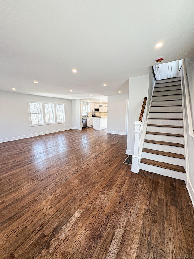 88 Walnut Trl, Danbury, CT 06810 - unfurnished living room with dark wood-type flooring, recessed lighting, baseboards, and stairs