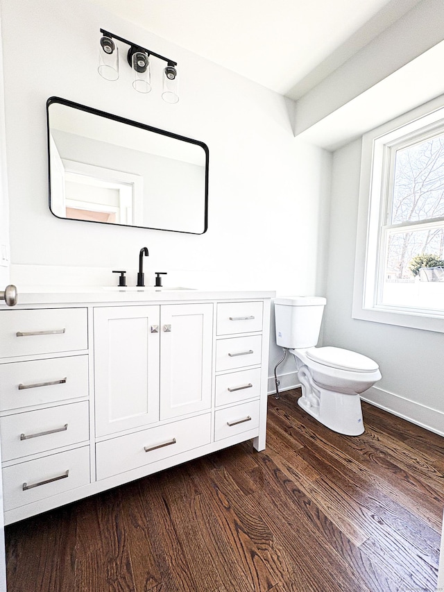 88 Walnut Trl, Danbury, CT 06810 - half bath featuring vanity, toilet, wood finished floors, and baseboards