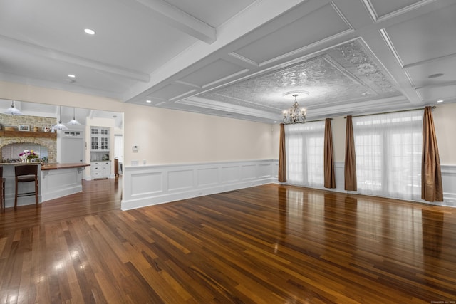 360 New London Tpke, Stonington, CT 06378 - spare room with a chandelier, wood finished floors, a wainscoted wall, and beam ceiling