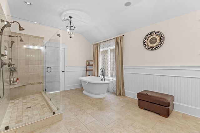 360 New London Tpke, Stonington, CT 06378 - bathroom featuring wainscoting, vaulted ceiling, a stall shower, a freestanding bath, and tile patterned flooring