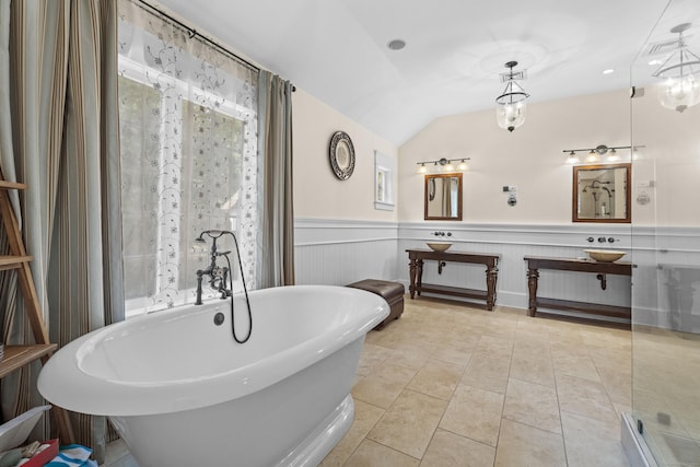 360 New London Tpke, Stonington, CT 06378 - bathroom with a freestanding bath, a wainscoted wall, vanity, tile patterned floors, and vaulted ceiling