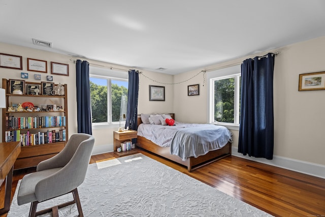 360 New London Tpke, Stonington, CT 06378 - bedroom featuring multiple windows, wood finished floors, and a desk