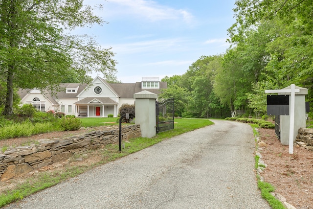 360 New London Tpke, Stonington, CT 06378 - view of front of house featuring stucco siding and a gate