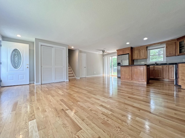 6 Perron Rd, Plainville, CT 06062 - unfurnished living room with a textured ceiling, light wood-type flooring, stairs, recessed lighting, and a ceiling fan