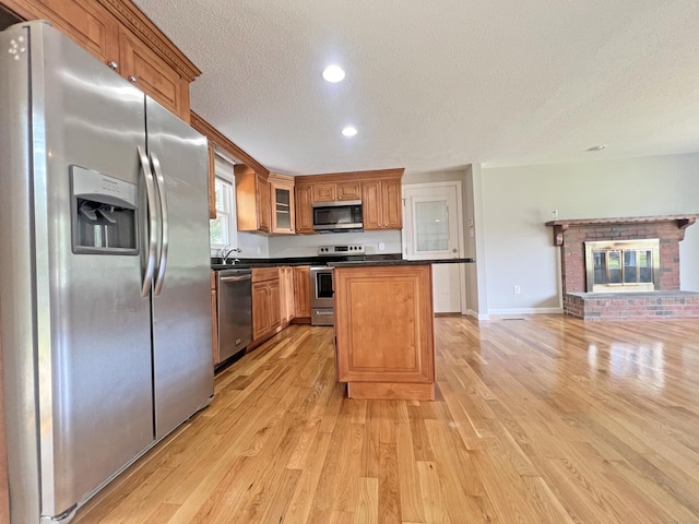 6 Perron Rd, Plainville, CT 06062 - kitchen with appliances with stainless steel finishes, a textured ceiling, light wood finished floors, dark countertops, and recessed lighting