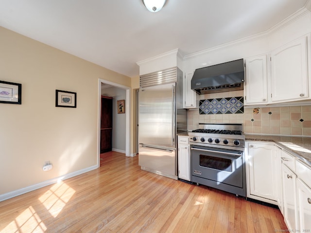 20 Copper Hill Dr Unit 20, Guilford, CT 06437 - kitchen featuring white cabinets, exhaust hood, light wood-style floors, high quality appliances, and backsplash