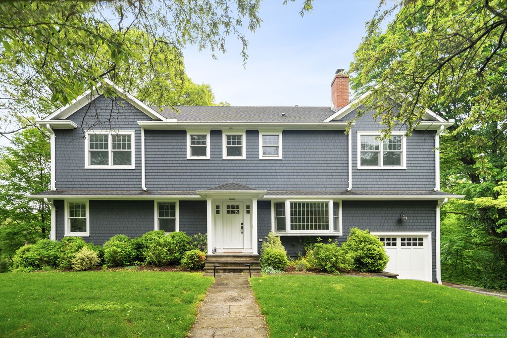 3 Burchard Ln, Norwalk, CT 06853 - shingle-style home with a chimney, a front lawn, a garage, and roof with shingles