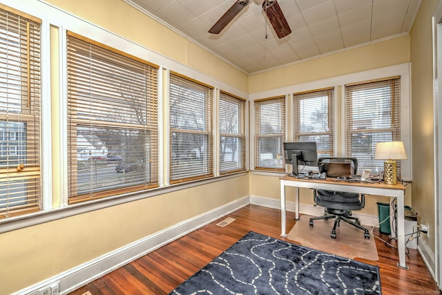 home office with visible vents, wood finished floors, ornamental molding, and a ceiling fan