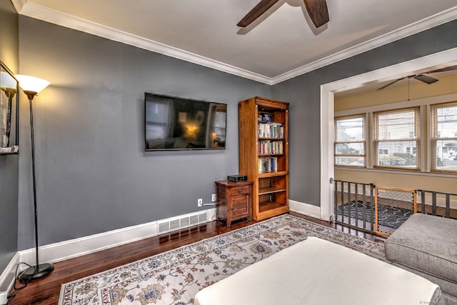 interior space featuring visible vents, wood finished floors, ceiling fan, and ornamental molding