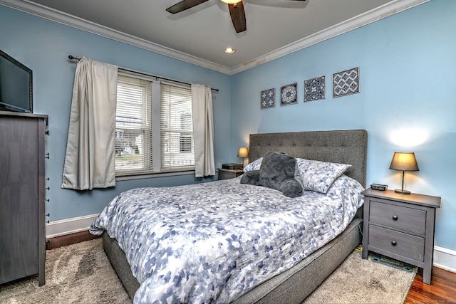 bedroom featuring baseboards, ornamental molding, wood finished floors, and ceiling fan
