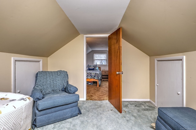 bedroom featuring baseboards, lofted ceiling, and carpet