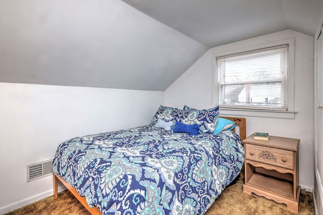 carpeted bedroom featuring baseboards, visible vents, and vaulted ceiling