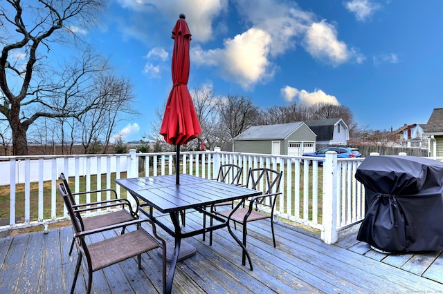 wooden deck featuring area for grilling and outdoor dining area
