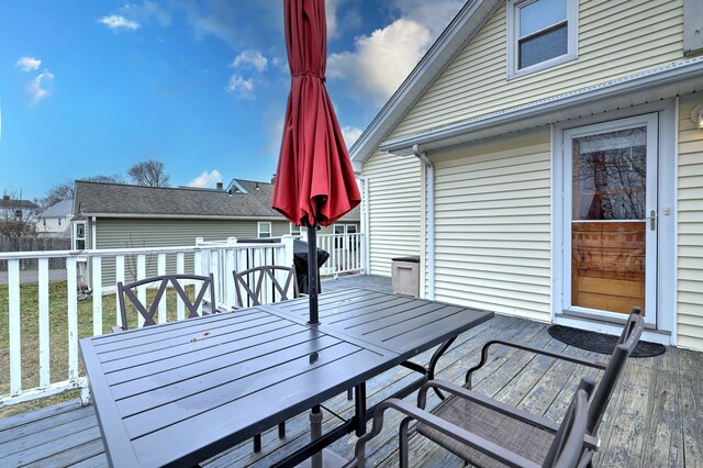 wooden terrace with outdoor dining area