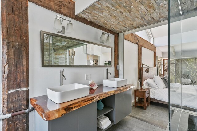 5 Deerfield Rd, Wilton, CT 06897 - full bath featuring wood finished floors, lofted ceiling, double vanity, and ensuite bath