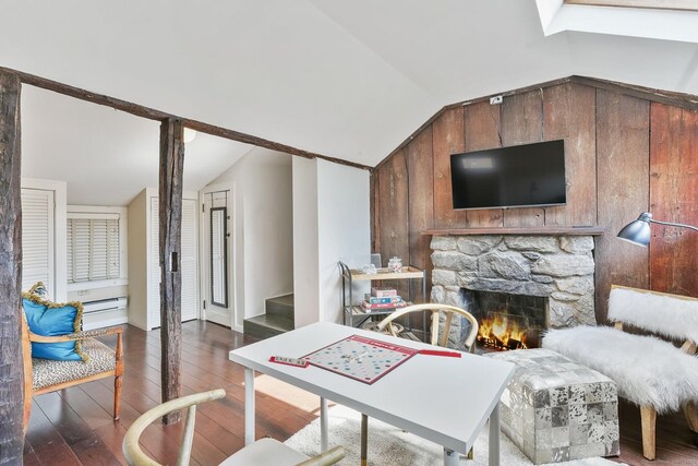 5 Deerfield Rd, Wilton, CT 06897 - living area with lofted ceiling, hardwood / wood-style floors, a stone fireplace, stairs, and a baseboard radiator