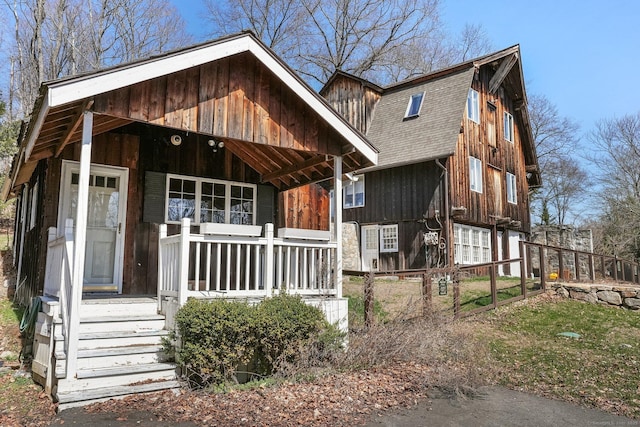 5 Deerfield Rd, Wilton, CT 06897 - rustic home featuring a shingled roof, covered porch, a gambrel roof, and fence