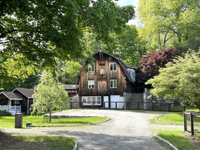 5 Deerfield Rd, Wilton, CT 06897 - view of front of property featuring curved driveway, fence, and a barn
