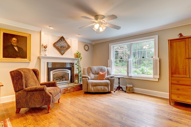 2 Whispering Pines Ln, Goshen, CT 06756 - sitting room featuring a ceiling fan, a fireplace, baseboards, light wood-style floors, and ornamental molding