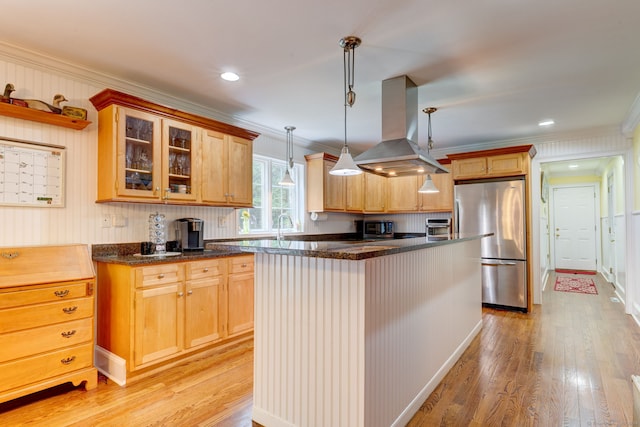 2 Whispering Pines Ln, Goshen, CT 06756 - kitchen with ornamental molding, glass insert cabinets, island range hood, light wood finished floors, and appliances with stainless steel finishes