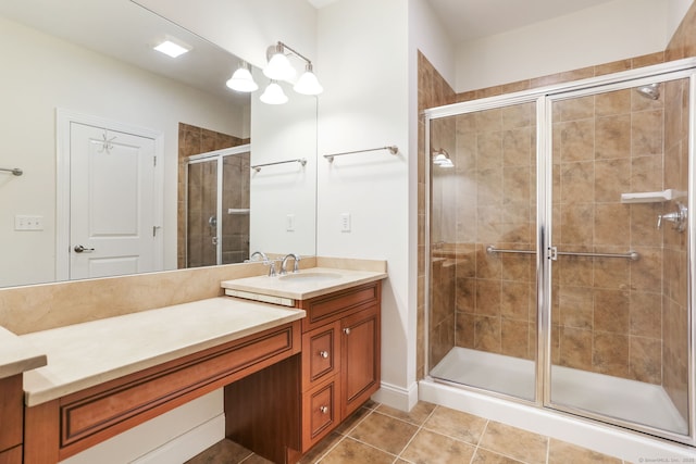 full bath with a stall shower, vanity, and tile patterned flooring