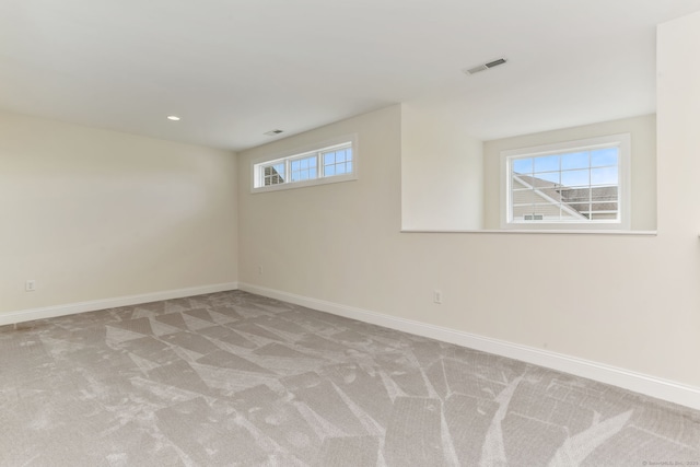 spare room with visible vents, baseboards, and carpet flooring