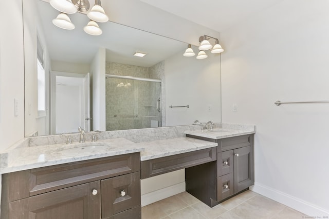 bathroom with tile patterned flooring, a sink, a stall shower, double vanity, and a notable chandelier