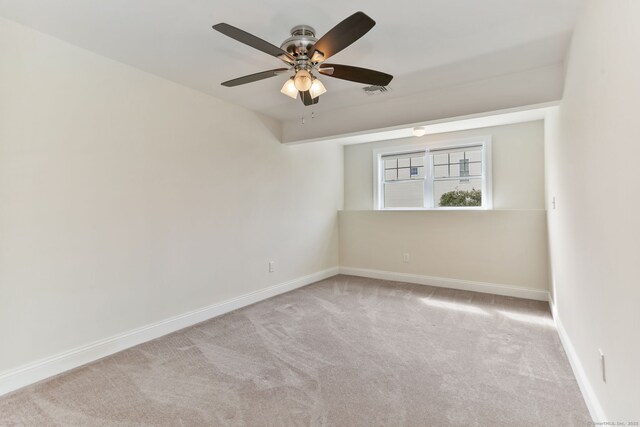 unfurnished room featuring visible vents, baseboards, a ceiling fan, and carpet flooring