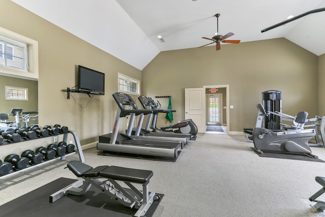 exercise room featuring carpet floors, baseboards, a ceiling fan, and high vaulted ceiling