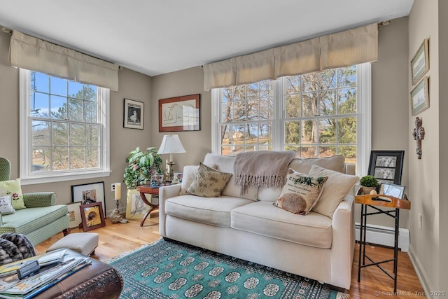 living room featuring baseboards, wood finished floors, and a baseboard radiator
