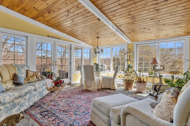sunroom featuring lofted ceiling, a notable chandelier, french doors, and wood ceiling