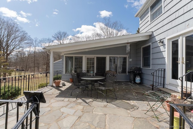 view of patio featuring french doors, fence, and a grill