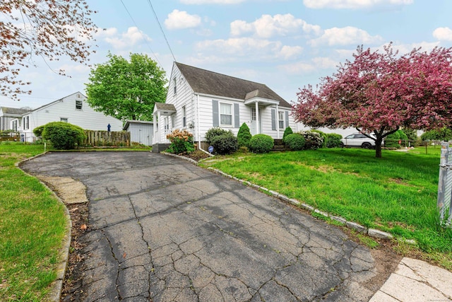 95 Vista Dr, East Haven, CT 06512 - view of front of home with roof with shingles, fence, driveway, and a front yard