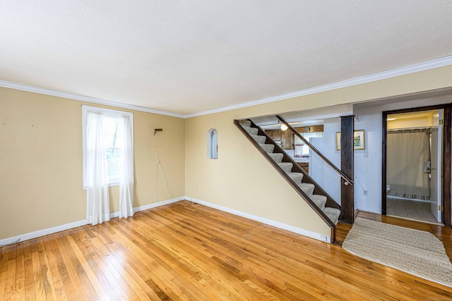 95 Vista Dr, East Haven, CT 06512 - interior space featuring crown molding, hardwood / wood-style floors, baseboards, stairway, and a textured ceiling