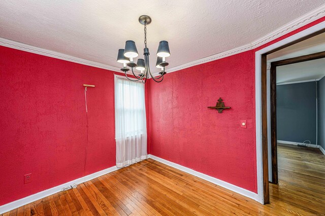 95 Vista Dr, East Haven, CT 06512 - unfurnished room featuring a textured wall, a notable chandelier, wood-type flooring, baseboards, and ornamental molding
