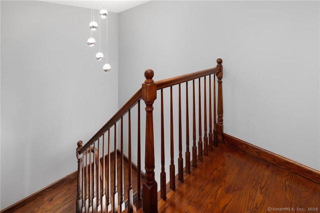 stairs featuring baseboards and wood finished floors