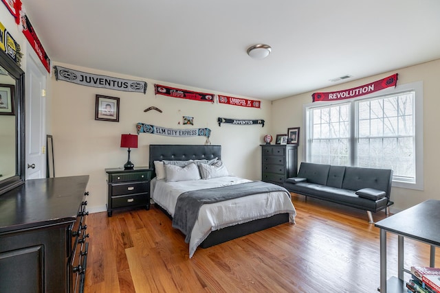 bedroom featuring light wood-style flooring and visible vents